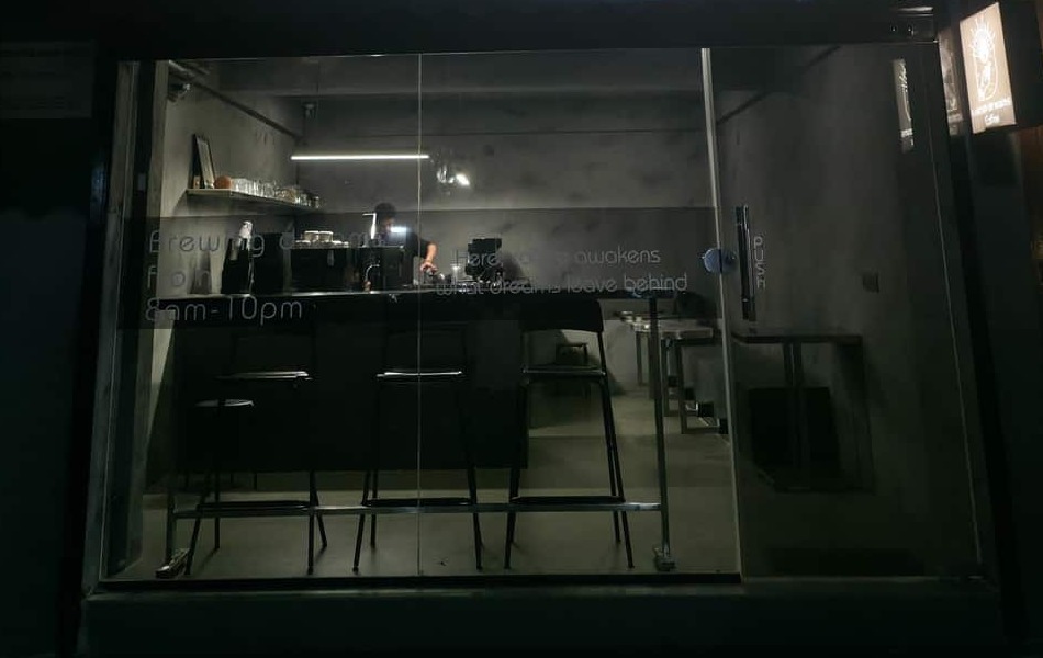 Cafe interior view through the storefront glass in Koramangala