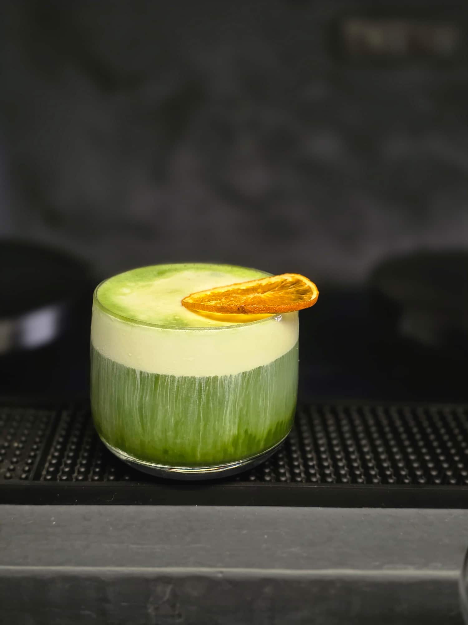 Iced matcha with dried orange garnish