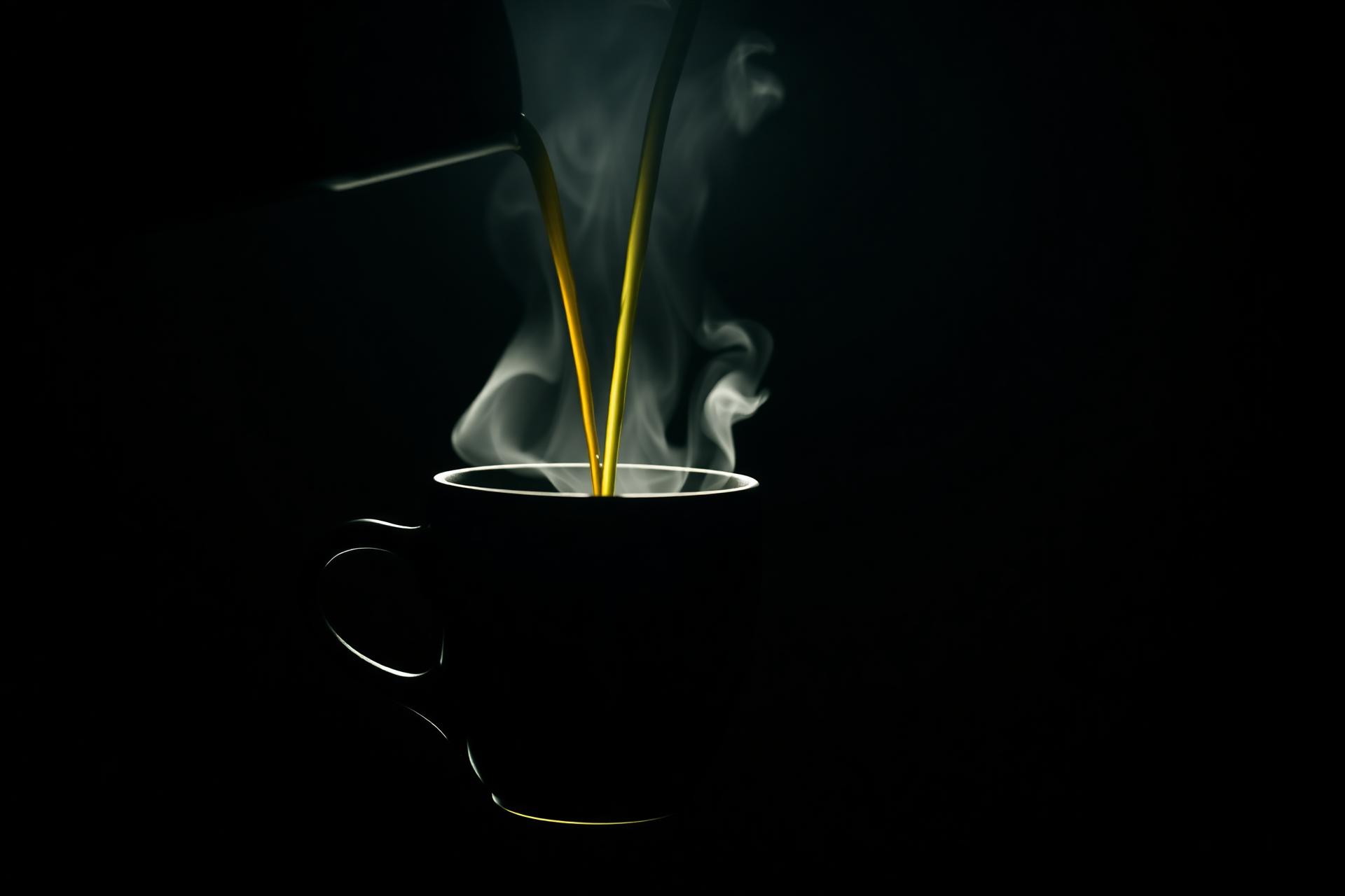 Espresso being poured with steam rising