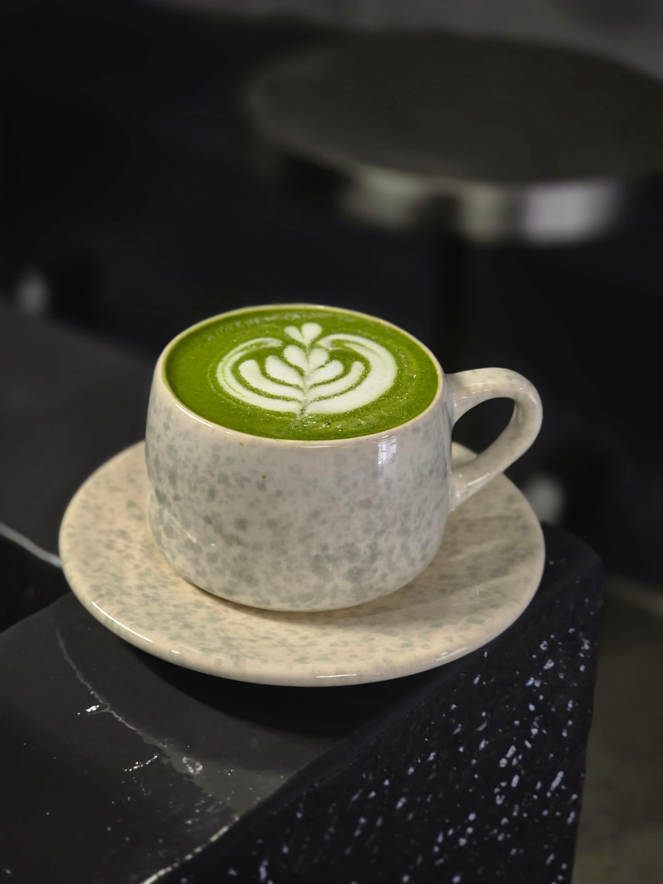 Iced matcha latte with dried orange garnish
